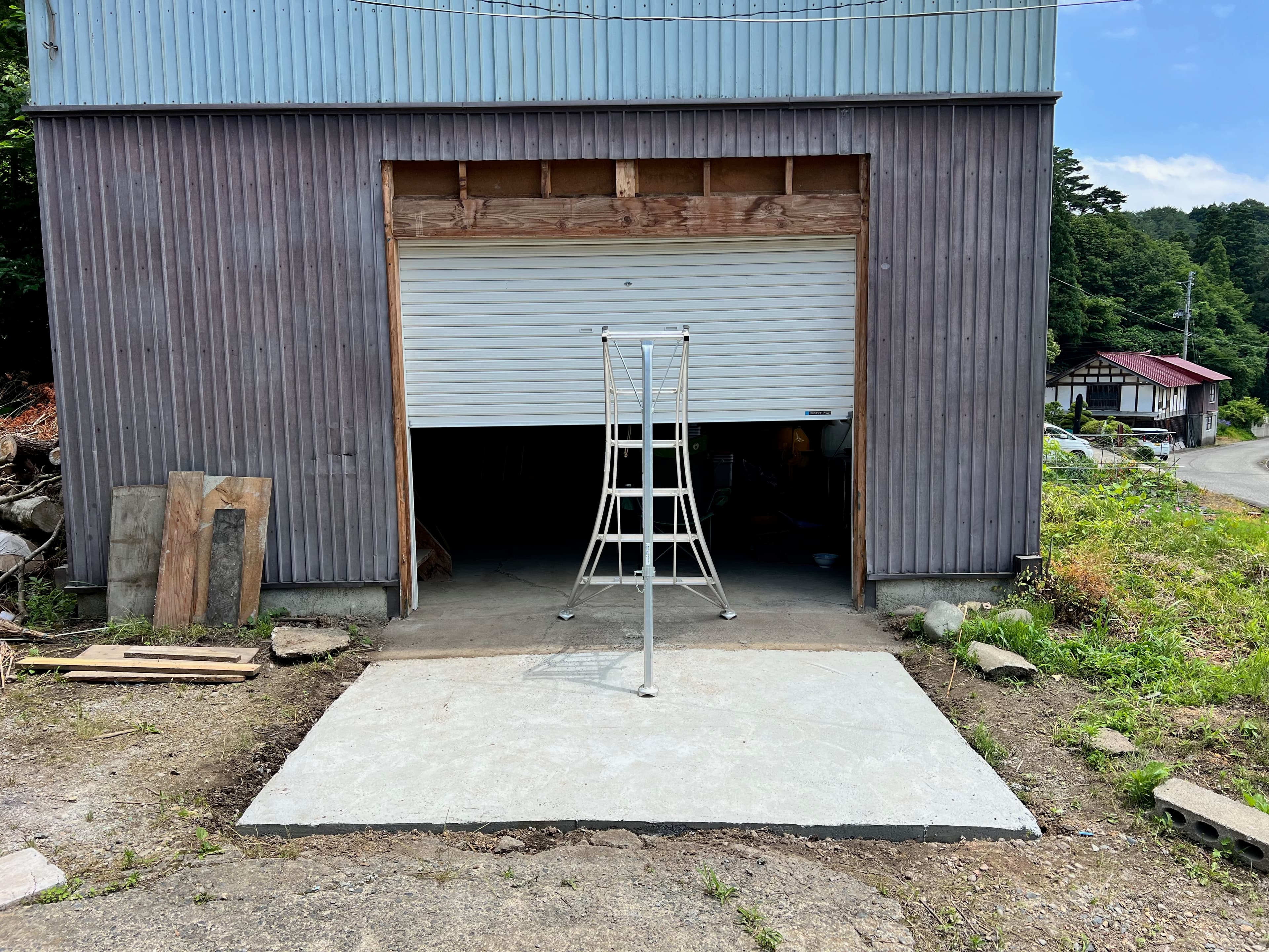 Garage entrance — concrete and shutter work, the before state