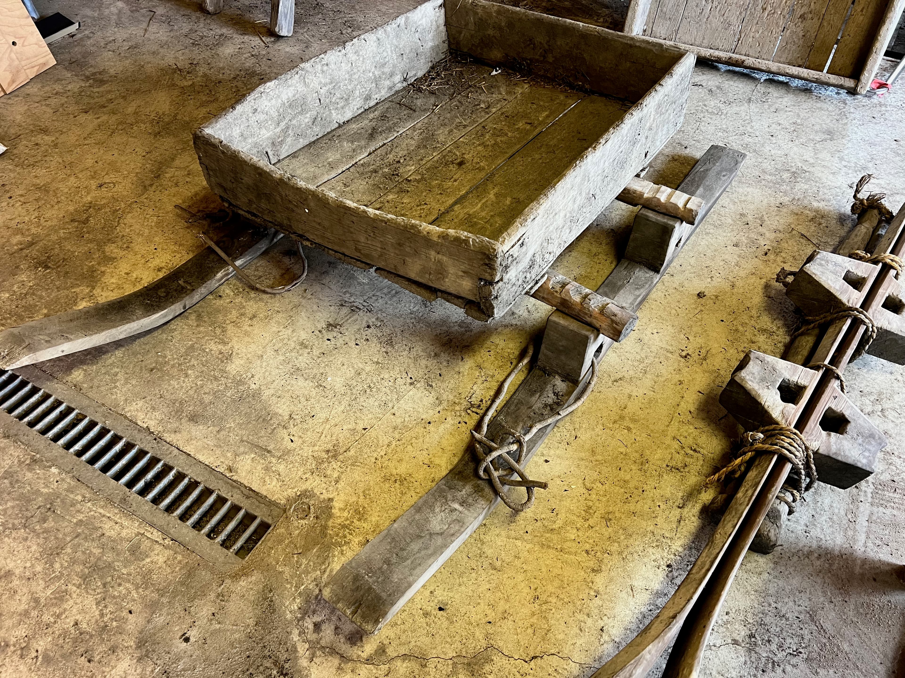 A wooden sled found in the garage — hand-carved runners, no metal, no adhesive